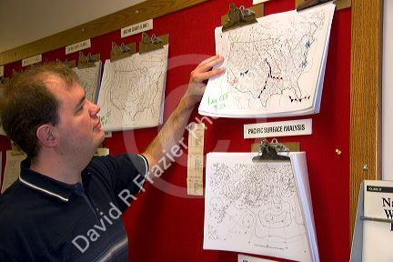 A student looking at maps in the Missouri Climate Center at the University of Missouri - Columbia.