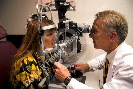 Ophthalmologist looks at patients eyes in the Mason Eye Institute at the University of Missouri - Columbia.