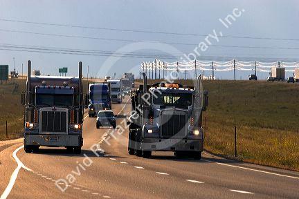 Semi trucks travel on Interstate 80 west of Cheyenne, Wyoming.
