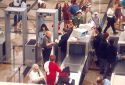 People going through security check points in the Denver International Airport.