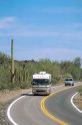 A motorhome passes saguaro cactus at the Organ Pipe National Monument in Arizona.