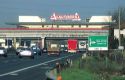 Autostrada toll road near Milan, Italy features a restaurant spanning the highway.