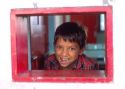 Native boy looking out the window of a riverboat on the Amazon River at Manaus Brazil.