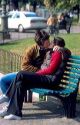Young lovers kissing on park bench at Verona, Italy.