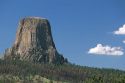 Tourists riding horses in front of Devils Tower National Monument, Wyoming.