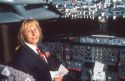 Female airline pilot reviewing checklist in cockpit of Boeing 737.