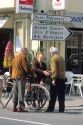 Elderly french people greet on the street.