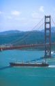 Ship traveling under the Golden Gate Bridge in San Francisco, California.