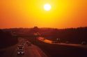 Automobiles traveling at sunset on Interstate 94 through Wisconsin.