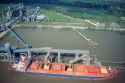 Bulk cargo ship takes on a load of grain on the Mississippi River near New Orleans, Louisiana.