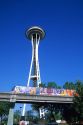 The monorail in Seattle, Washington travels in front of the Space Needle.