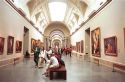 Interior of the Prado art museum showing paintings and vistors in Madrid, Spain.