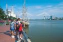 Riverfront and port in Savannah, Georgia with suspension bridge across the Savannah River.