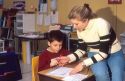 Elementary school teacher helping a student in her classroom.  MR