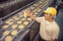 Corn tortilla factory in Caldwell, Idaho.  Manager checks quality of product.