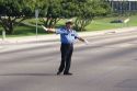 Male traffic officer blowing a whistle, directing traffic in Los Angeles, California.