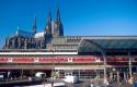 Train station at Cologn, Germany.  In German it is called the Hauptbahnhof. Ancient Roman Catholic Cathedral towers behind.