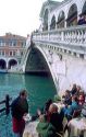 Outdoor cafe at the Rialto Bridge which spans the Grand Canal in Venice, Italy.
