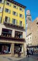 Pedestrian street scene in Verona, Italy.  Tower is the Torre del Lamberti.