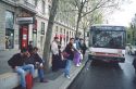 People waiting at a bus stop in Lyon, France.