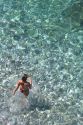 Bather enters the clear waters of the French Riviera and the Mediterranean.