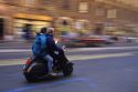 People riding a scooter in Rome, Italy.