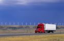 A truck traveling on the highway with a row of windmills in the background near Arlington, Wyoming.