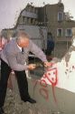 A man chipping off a piece of the Berlin Wall, Germany.