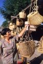 A woman buying baskets in Chinbarongo, Chile.