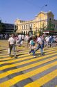 People using a crosswalk in front of the library in Santiago, Chile.