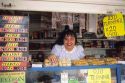 A woman clerk working in a candy stand, Venezuela.