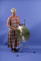 A woman playing a gong.