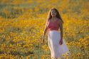 A woman walking through a field of wildflowers in Idaho.