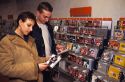 Young people shopping for CD's in an Italian music store.