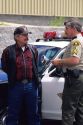 A sheriff deputy reads miranda rights to a suspect. MR