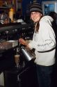 A female employee making coffee drinks at a coffee shop in Boise, Idaho.