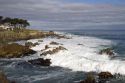 Waves crash along the rocky shore in Monterey, California.