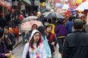 People walking with umbrellas in Chinatown, San Francisco, California.