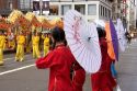 Girls hold umbrellas while performing in the Chinese New Year Parade, Chinatown, San Francisco, California.