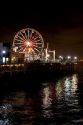 Ferris wheel and lights at night on the Santa Monica pier, California.
