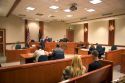 Court room scene with  in Boise, Idaho.  Criminal defendant  and lawyer sit with backs to camera.