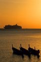 A cruise ship at sunset of the coast of Phuket Island, Thailand.