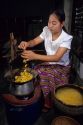Thai woman spins silk from silkworm cacoons, Thailand.