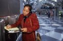 Hawaiian woman using a pay phone at Chicago's O'hare airport.  (MR)