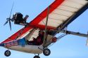 An ultralight aircraft flying in the sky.