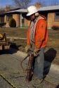 Worker with protective gear uses a jackhammer.