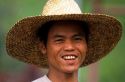 Portrait of a Filippino farmer wearing a straw hat.