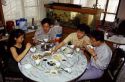 Chinese people eating a meal in a home, Taiwan.