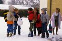 Children dressed for cold weather and snow.