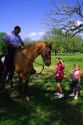 African american police officer on horseback speaking to children in New Orleans, Louisiana.